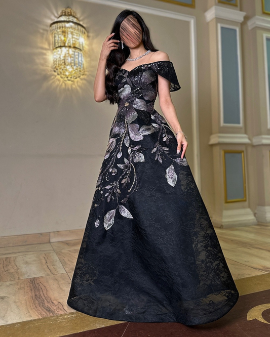 Black evening dress embroidered with leaf patterns