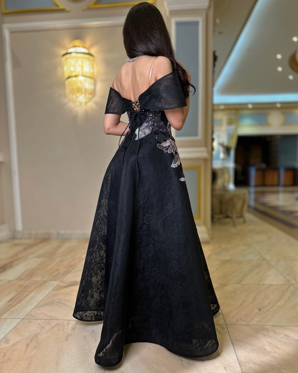 Black evening dress embroidered with leaf patterns